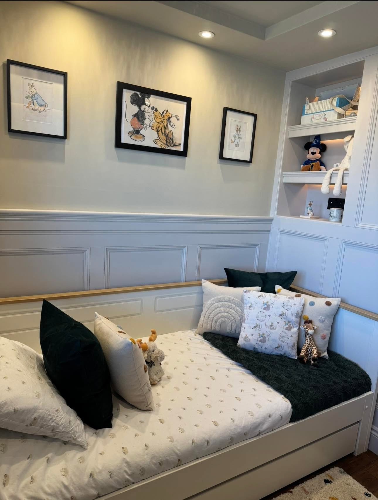 Child's bedroom panelled alcove bed detail with dado panelling, oak capping rail, framed prints and lit shelving niche