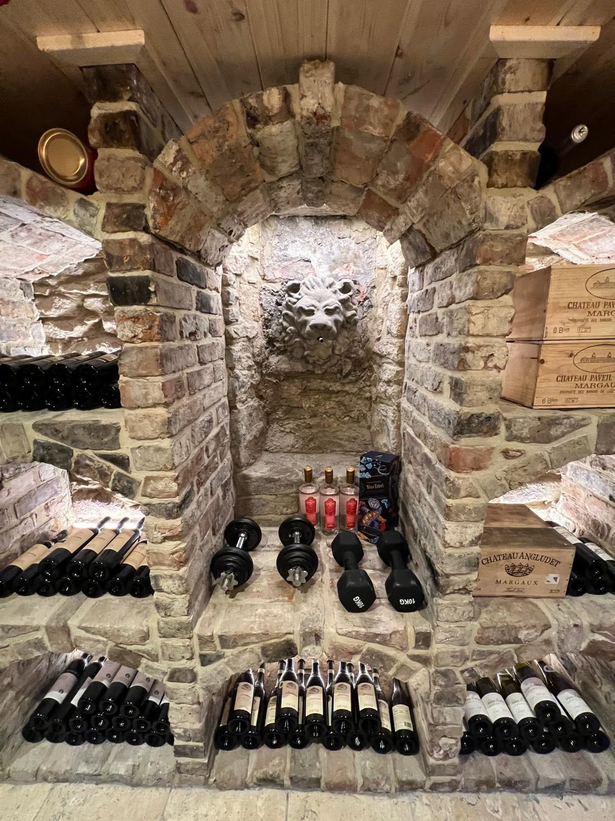 Alternate angle of the lion mask arch and brick vaulting in the cellar