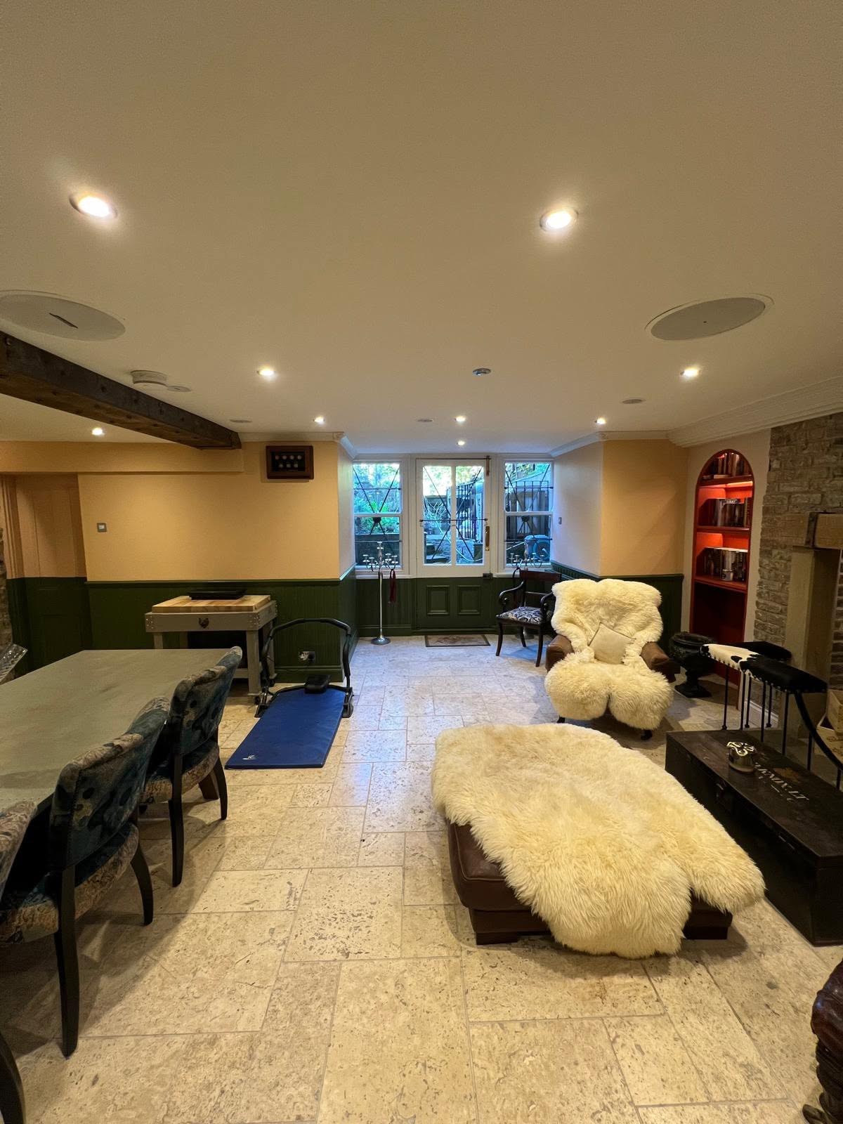 Basement toward new light well window with green panelled wainscot and arched red-lacquered niche