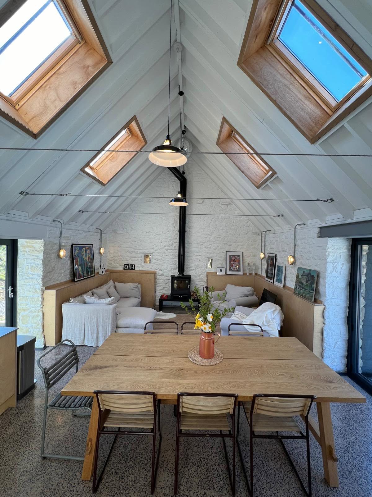 Symmetrical view down the vault with four oak rooflights, log burner on the gable and ply dado picture ledge