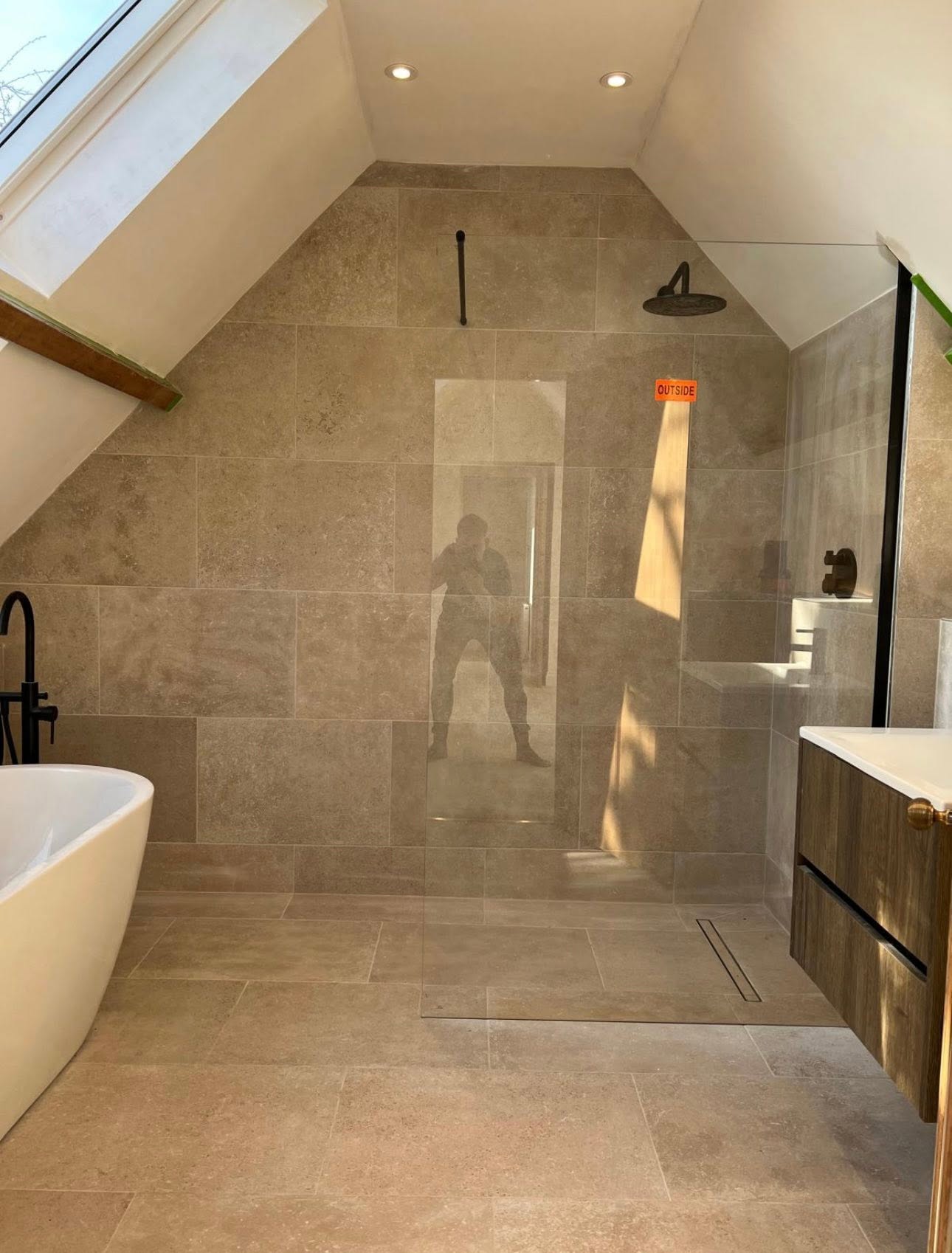Loft ensuite with stone tiled walk in wet room and freestanding bath