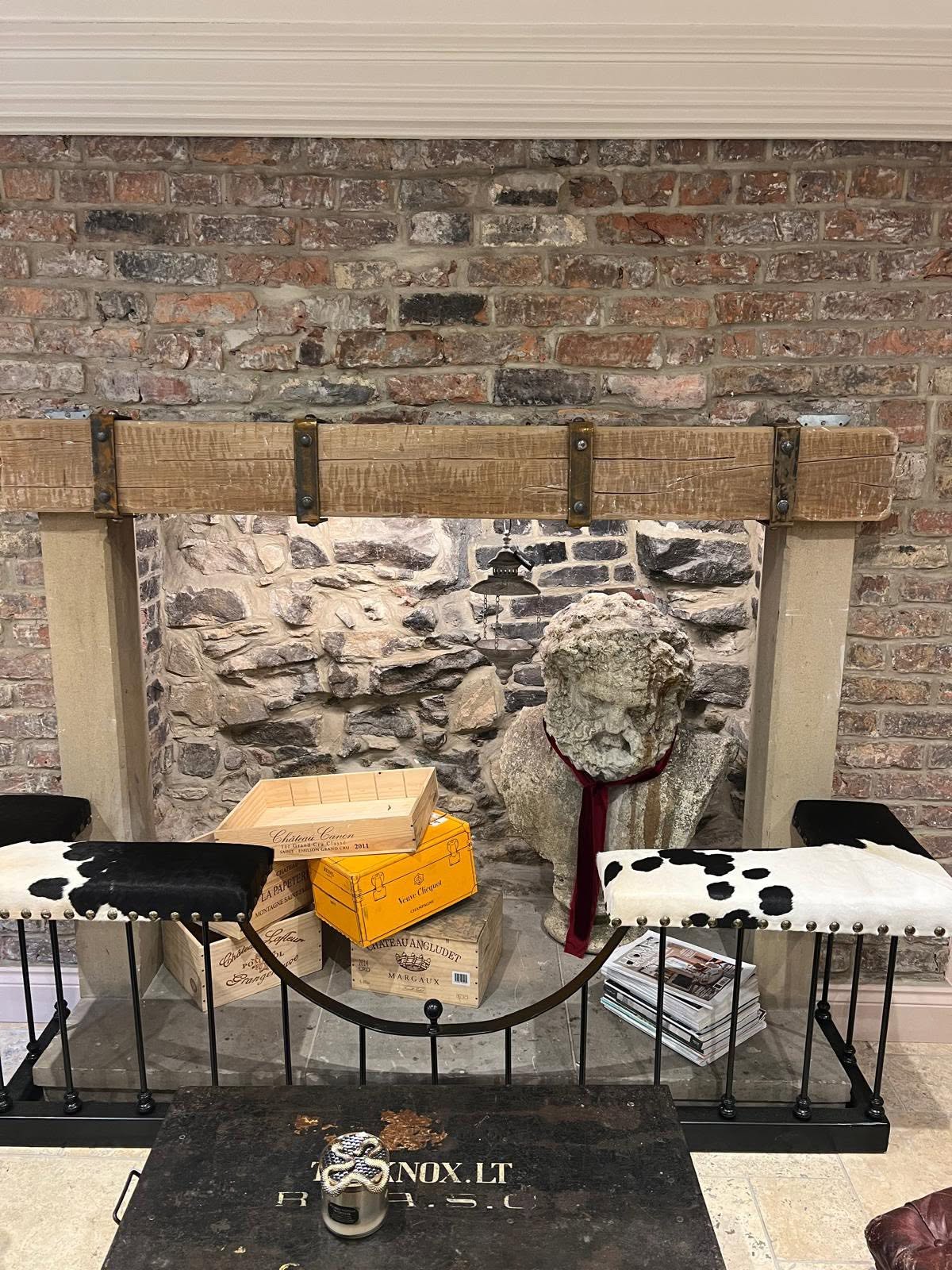 Restored inglenook fireplace with reclaimed brick chimney breast, sandstone jambs and reclaimed oak bracing beam