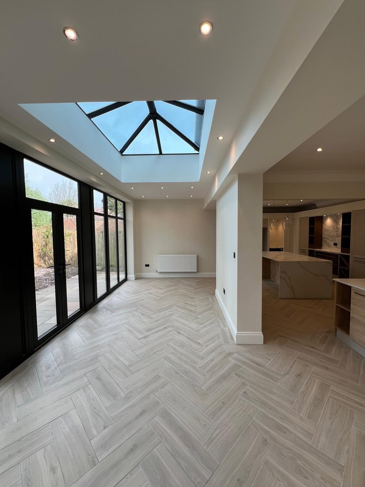 Open plan living area with kitchen island and roof lantern in Gosforth