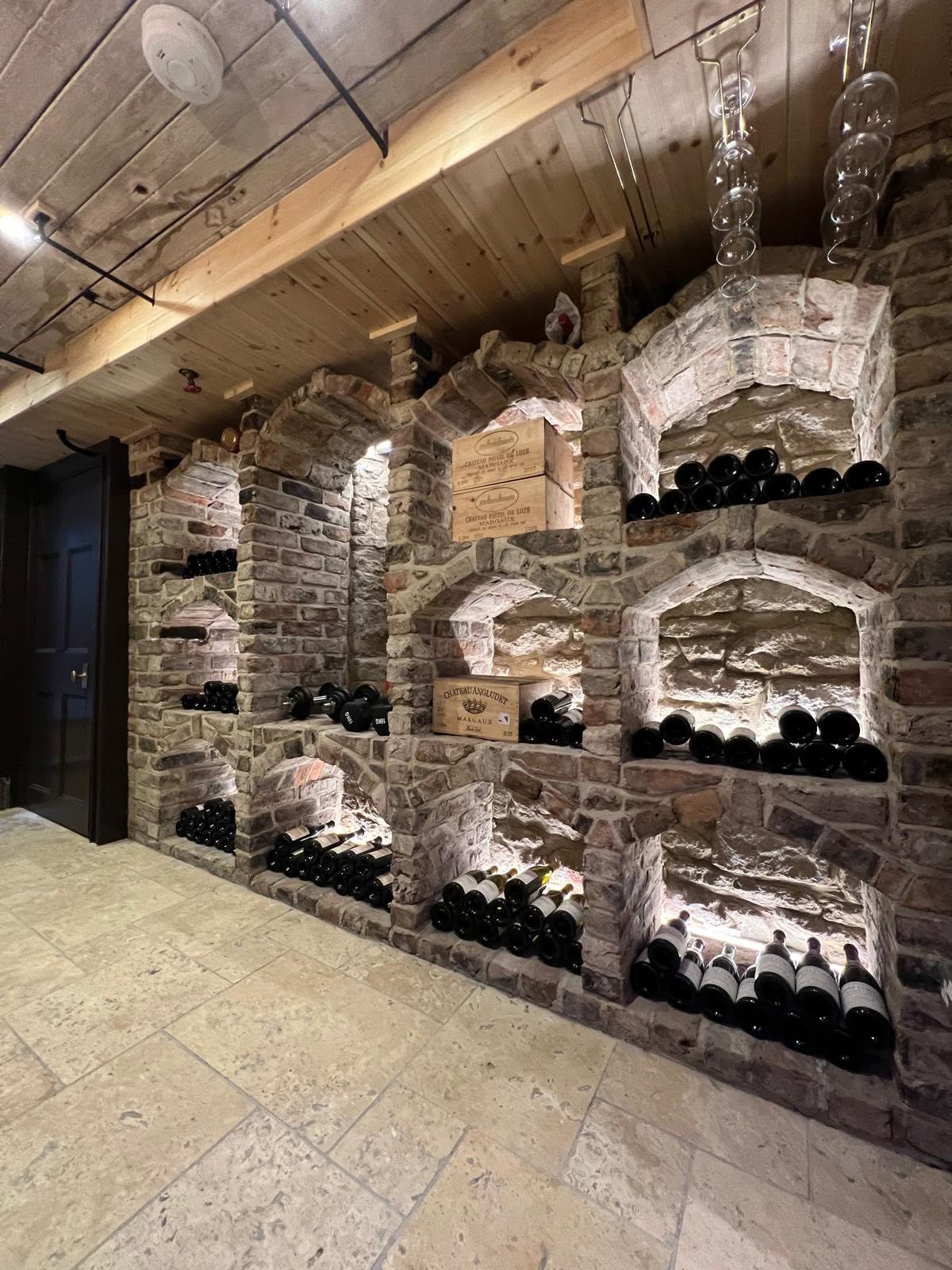 Cellar elevation showing full run of arched niches and glass hanging rack