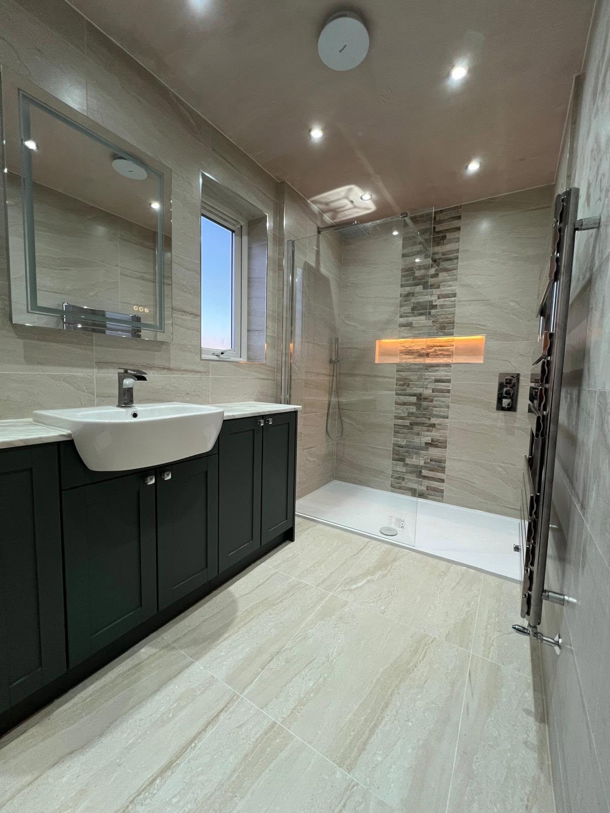 Wet room shower elevation with split face mosaic feature strip, lit recessed niche and ceiling rain head