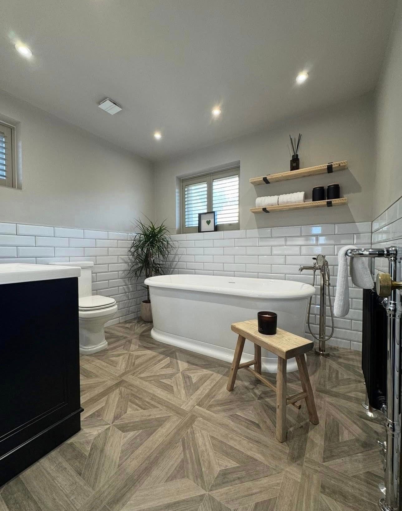 Family bathroom with white bath, metro tiling and timber effect flooring